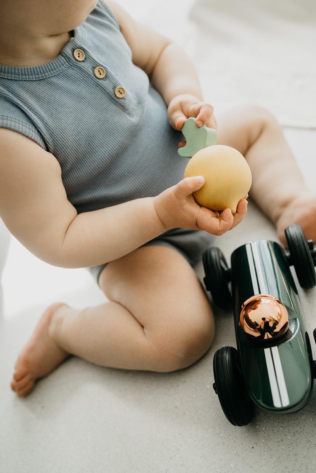 buttoned sleeveless bodysuit · blue iris